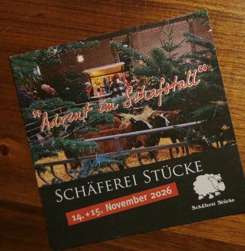 Einladungskarte „Advent im Schafstall“ der Schäferei Stücke, 14. und 15. November 2026: Schafe im Stall zwischen Tannenbäumen, dahinter Besucher am Stand